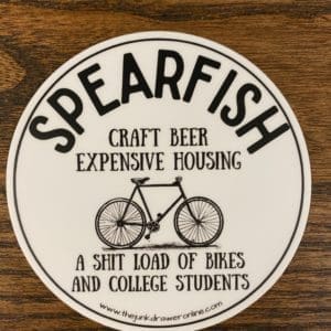 Spearfish sticker with a bicycle and the text craft beer expensive housing a shit load of bikes and college students