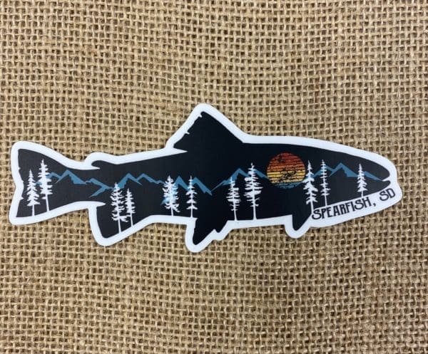 Spearfish, SD sticker in a fish shape with hills, trees, and a sun design within the fish shape.