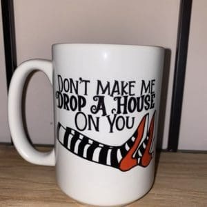 Custom mug with don't make me drop a house on you text above stripped leggings with red color heels