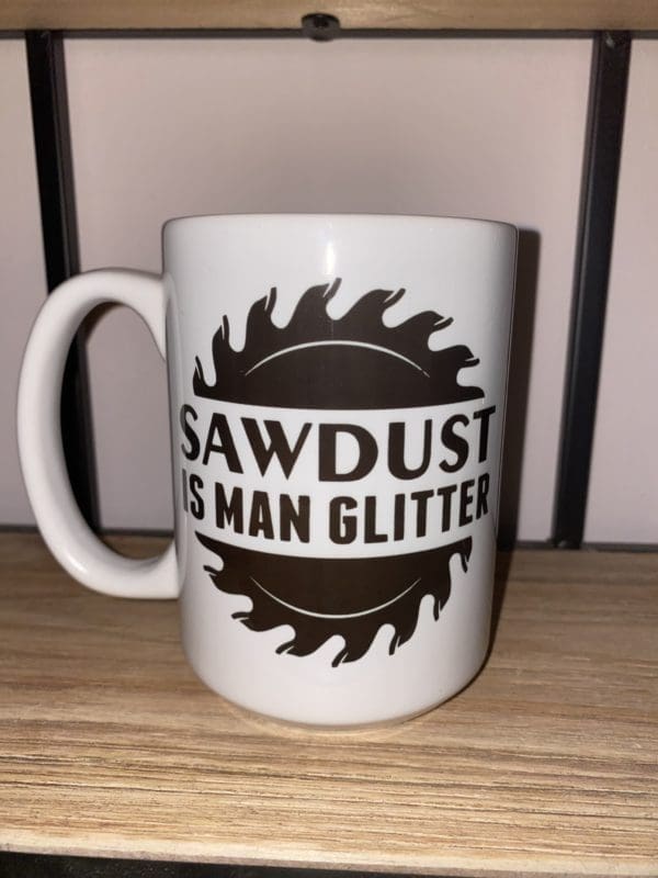 Custom mug with a sawblade split in the middle with sawdust is man glitter text